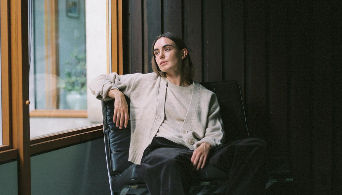 A woman wearing a layered chunky knit sweater